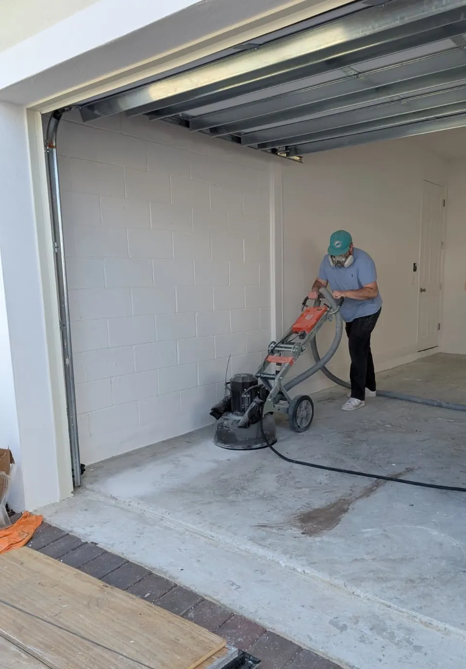 Concrete grinding prep before epoxy and polyaspartic garage floor coating