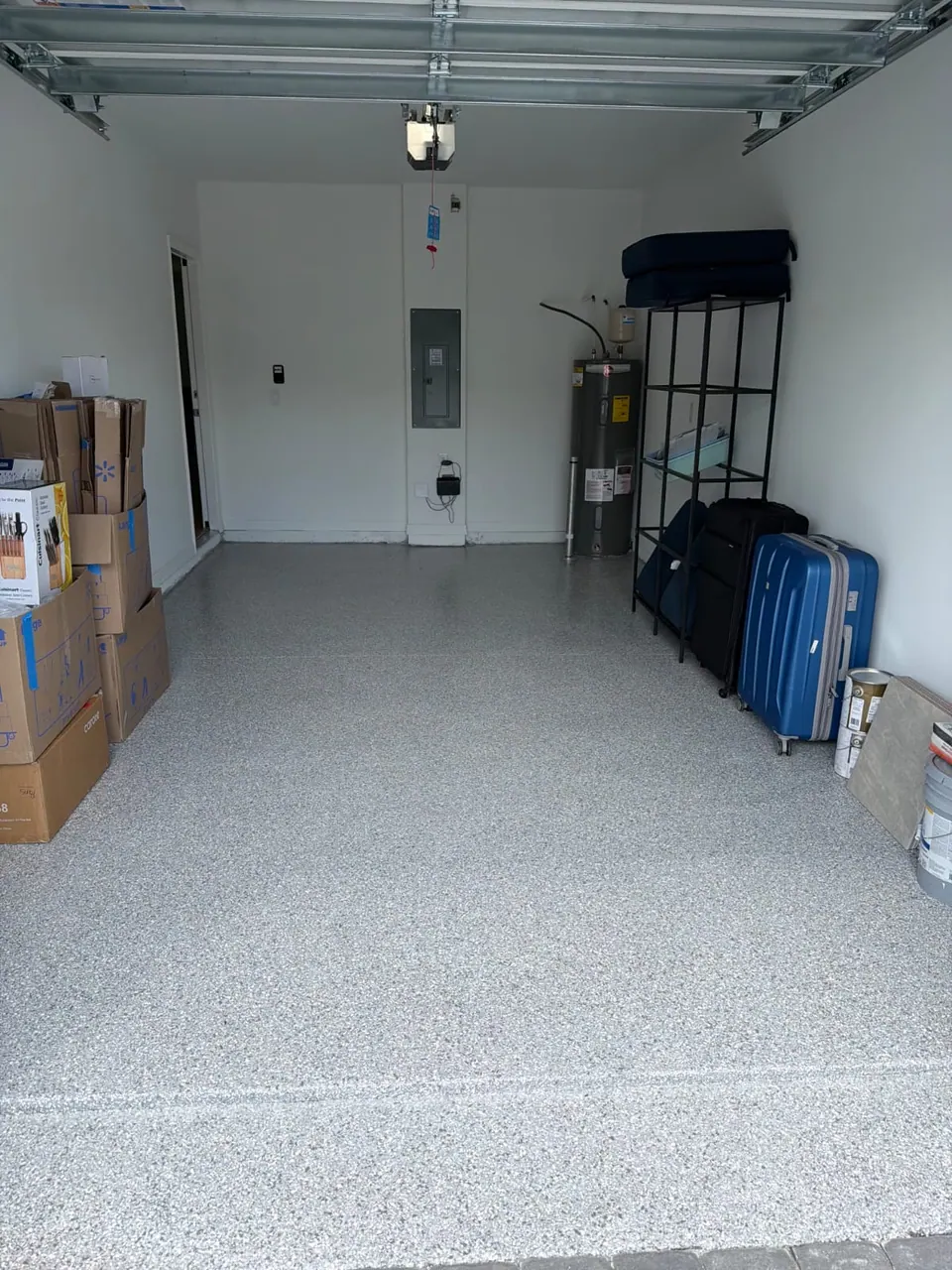 Gray flake garage floor coating with shelving and household storage