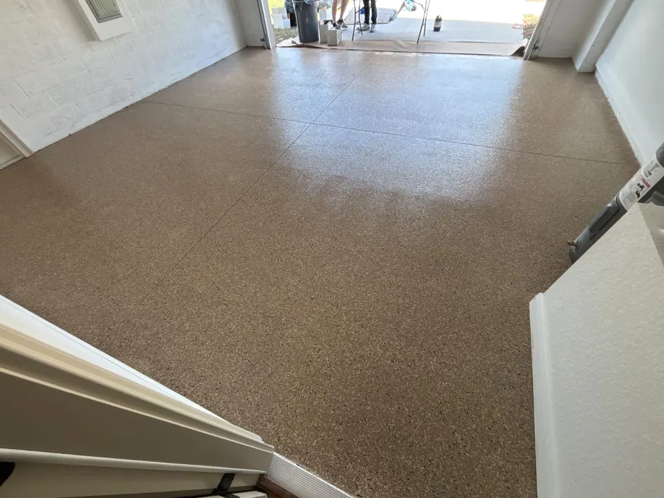 Tan flake garage floor showing the coated surface and control joints