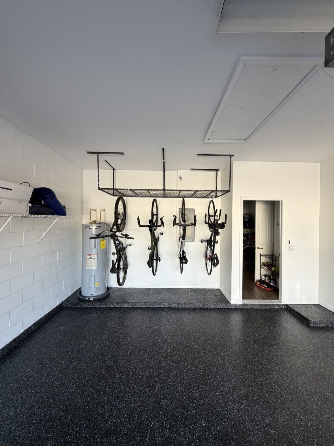 Finished carbon flake garage floor coating with overhead storage racks