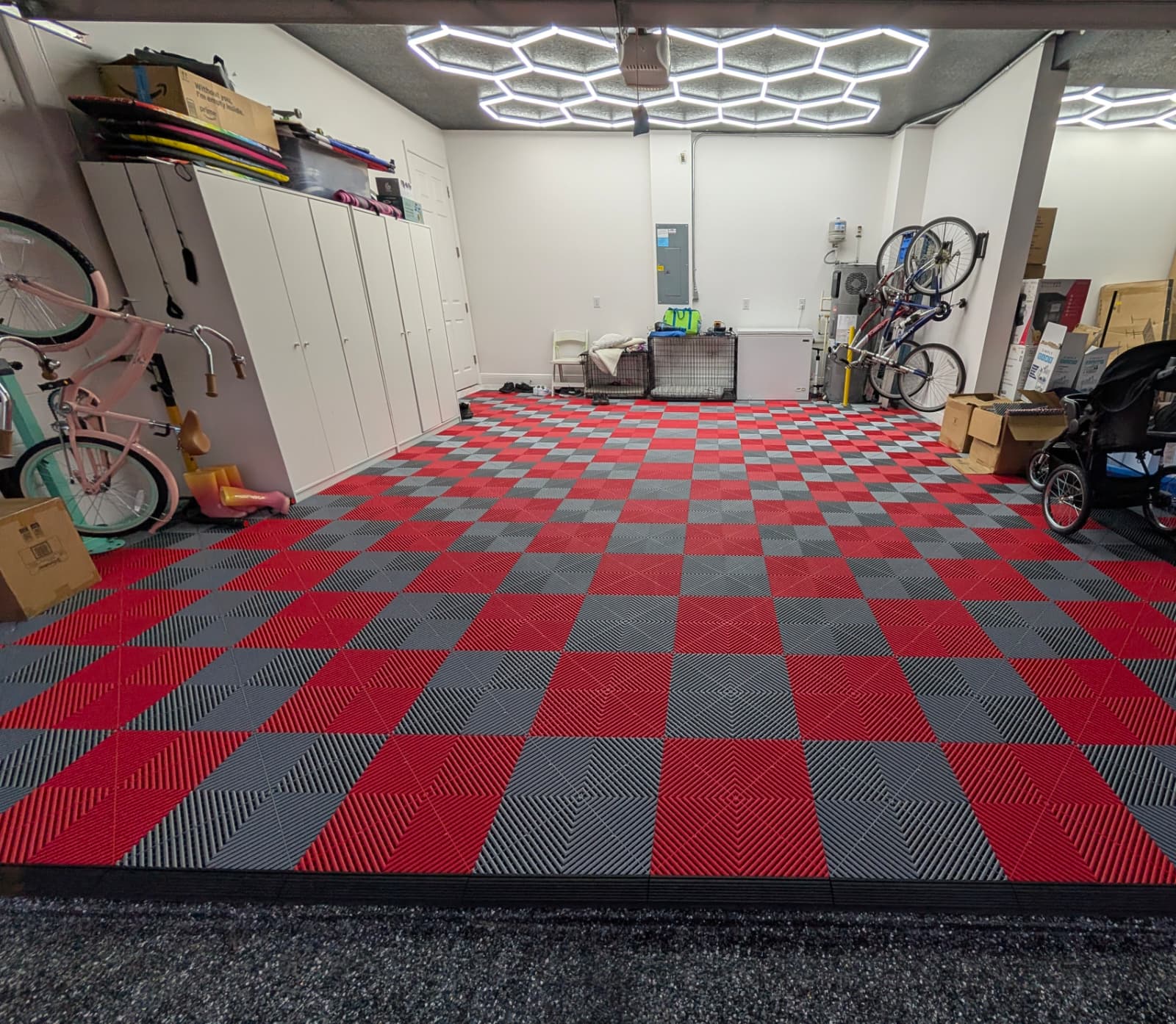 Red and gray modular garage floor tiles with hex garage lighting
