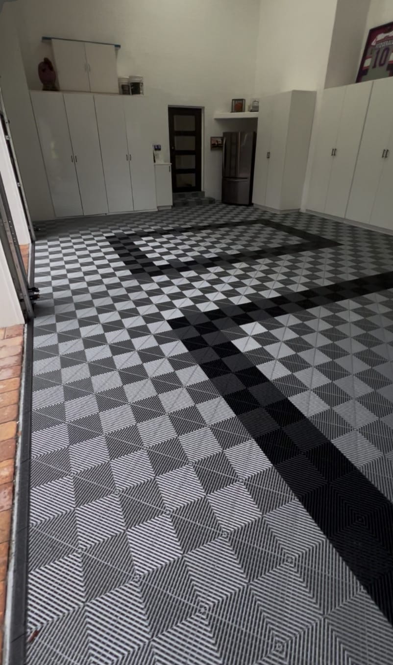 Gray and black modular garage floor tiles in a finished garage