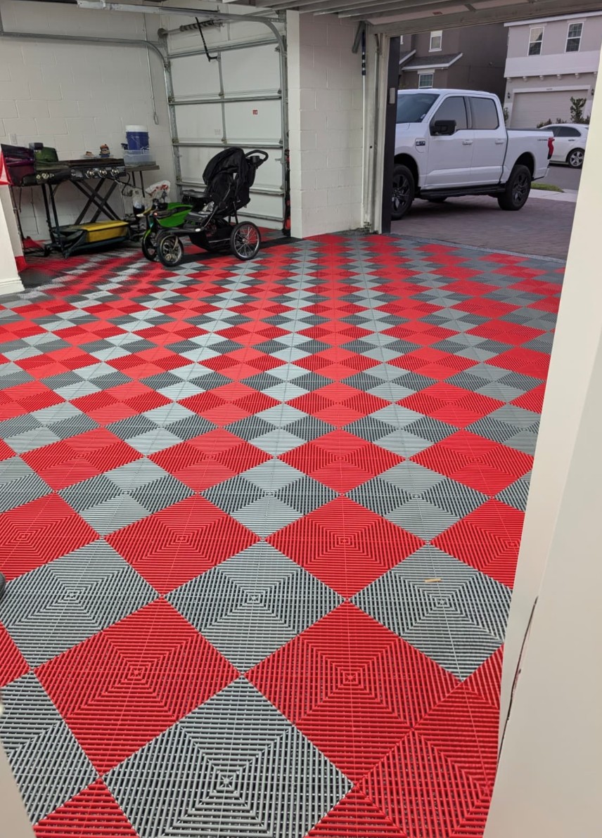 Red and gray garage floor tile layout in an open garage